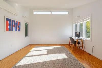an empty white room with a desk and a window at Modern Lakefront Retreat w King Bed in Saugerties