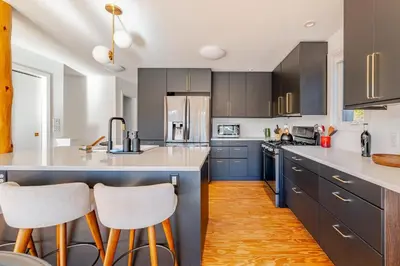 a kitchen with blue cabinets and white counter tops at Modern Lakefront Retreat w King Bed in Saugerties