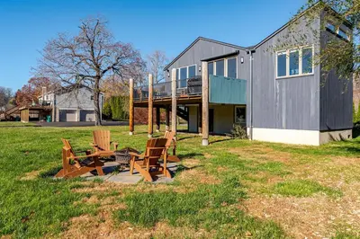 a house with two chairs and a table in a yard at Modern Lakefront Retreat w King Bed in Saugerties