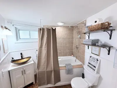 a bathroom with a tub and a toilet and a sink at Cozy Pocono Escape in Tobyhanna
