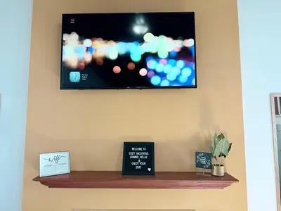 a flat screen tv hanging on a wall at Cozy Pocono Escape in Tobyhanna