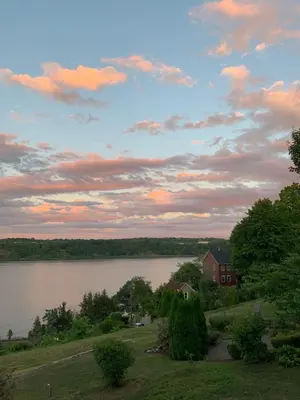 a view of a lake with a house and a building at The Huron stunning water views and family home vibes in Milton in Milton