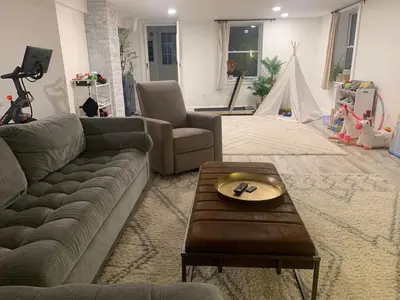 a living room with a couch and a table at The Huron stunning water views and family home vibes in Milton in Milton