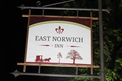 a sign for an east norfolk inn on a pole at East Norwich Inn in East Norwich