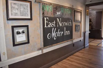 a sign on the wall of a museum at East Norwich Inn in East Norwich
