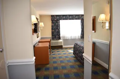 a hotel room with a bed and a window at East Norwich Inn in East Norwich