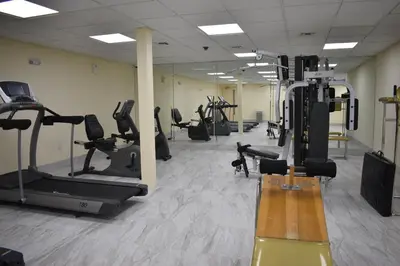 a gym with treadmills and elliptical machines at East Norwich Inn in East Norwich