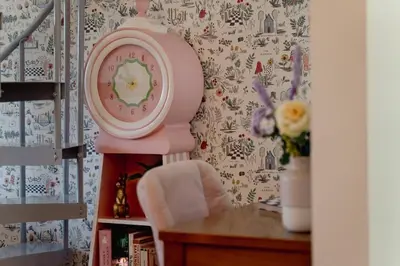 a pink clock sitting on top of a table at Alice in Wonderland Pocono Home in Honesdale