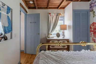 a bedroom with a bed and a blue door at Alice in Wonderland Pocono Home in Honesdale