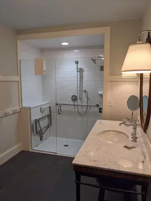 a bathroom with a shower with a sink and a glass shower stall at Hotel on North in Pittsfield