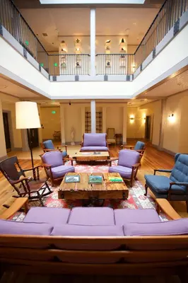 a large living room with a couch and chairs at Hotel on North in Pittsfield