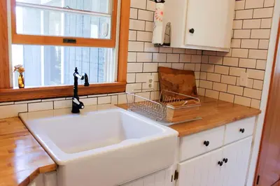 a kitchen with a white sink and a window at Bellwood Cottage 8-14min to all Roxbury Wed Venues in Roxbury