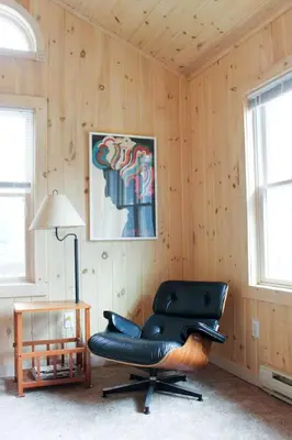 a black leather chair in a room with wooden walls at Bellwood Cottage 8-14min to all Roxbury Wed Venues in Roxbury
