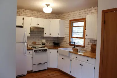 a kitchen with white cabinets and a white refrigerator at Bellwood Cottage 8-14min to all Roxbury Wed Venues in Roxbury