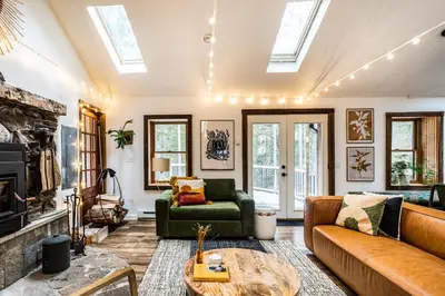 a living room with a couch and a table at Stunning Catskills Cabin in Margaretville