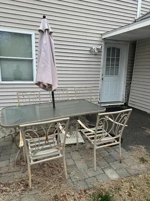 a table and chairs with an umbrella on top of it at LINMOTA Vacation Home in Watertown
