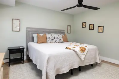 a bedroom with a bed and a ceiling fan at Lakefront Luxury at Stony Pointe in Ballston Spa