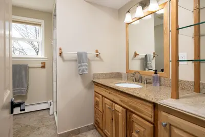 a bathroom with a sink and a mirror at Lakefront Luxury at Stony Pointe in Ballston Spa