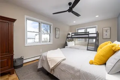 a bedroom with a bed and a bunk bed at Lakefront Luxury at Stony Pointe in Ballston Spa