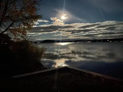 a view of a large body of water with the sun at Lakefront Luxury at Stony Pointe in Ballston Spa