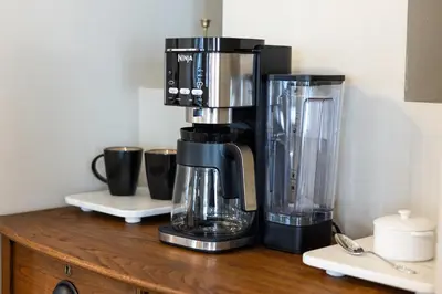 a coffee maker sitting on top of a wooden counter at Lakefront Luxury at Stony Pointe in Ballston Spa