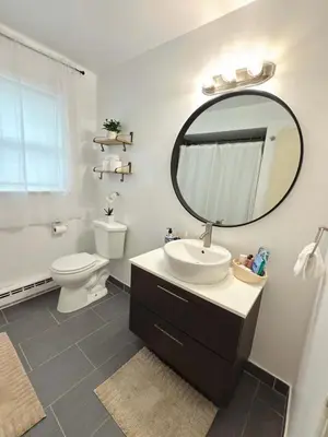 a bathroom with a sink and a toilet and a mirror at Independence Day Best Fireworks View July 6 in Clifton