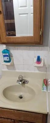 a bathroom counter with a sink and a mirror at Beautiful Room 10D in Newark