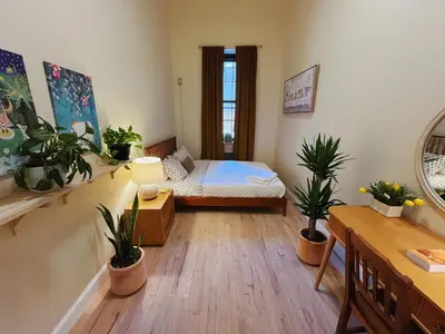 a room with a bed and potted plants in it at Interfaith 21st Street in New York