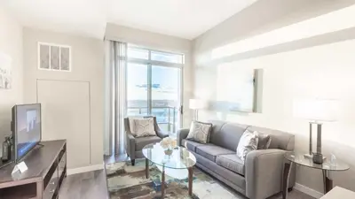 a living room with a couch and a tv at Modern Apartment In Harbor Point in South End