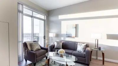 a living room with a couch and two chairs and a table at Modern Apartment In Harbor Point in South End