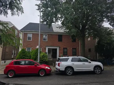two cars parked in front of a house at Astoria, steps away from Manhattan in Astoria