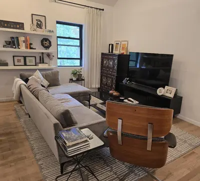 a living room with a couch and a television at Astoria, steps away from Manhattan in Astoria