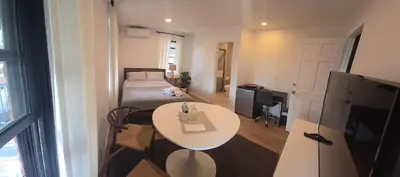 a room with a bed and a table and a television at Astoria, steps away from Manhattan in Astoria