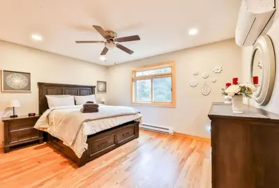a bedroom with a bed and a ceiling fan at Lakeside Catskills Escape - Soak, Sip, Stargaze in Cairo