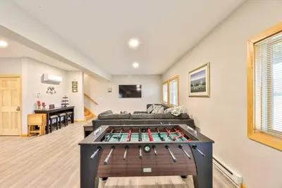 a living room with a ping pong table at Lakeside Catskills Escape - Soak, Sip, Stargaze in Cairo