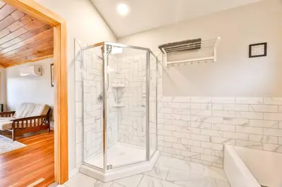 a shower in a bathroom with a glass shower stall at Lakeside Catskills Escape - Soak, Sip, Stargaze in Cairo
