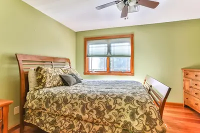 a bedroom with a bed and a window at Catskills retreat - ATV, Hot tub, hiking, fishing in Cairo