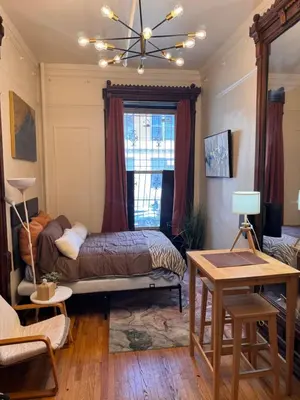 a bedroom with a bed and a window at The Parlor in New York