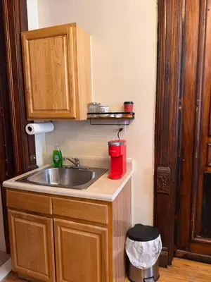 a kitchen with a sink and a red container at The Parlor in New York