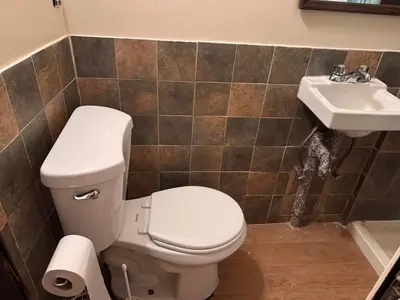 a bathroom with a toilet and a sink at The Parlor in New York