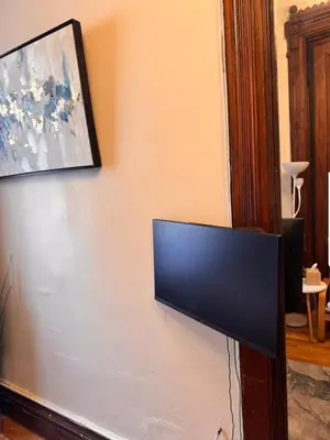 a flat screen tv hanging on a wall at The Parlor in New York