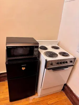a kitchen with a stove and a microwave at The Parlor in New York