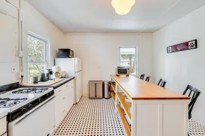 a kitchen with white cabinets and a stove top oven at 7 Mi to Belleayre Ski Mountain Getaway with Porch in Fleischmanns