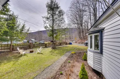 a yard with a fence and a house at 7 Mi to Belleayre Ski Mountain Getaway with Porch in Fleischmanns