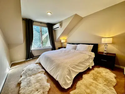 a bedroom with a large bed and a window at Windham Ridge Chalet in Windham