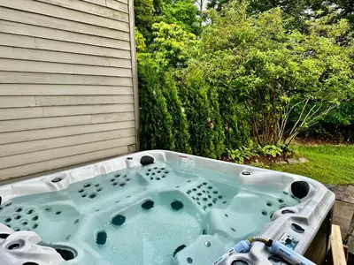 a bath tub sitting on the side of a house at Windham Ridge Chalet in Windham