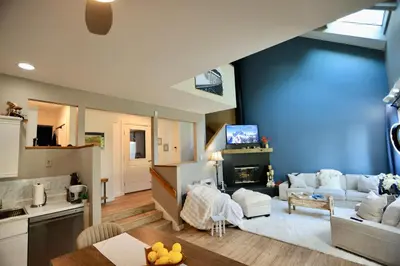 a living room with a couch and a fireplace at Windham Ridge Chalet in Windham