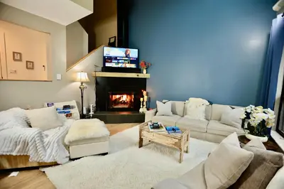a living room with a couch and a fireplace at Windham Ridge Chalet in Windham