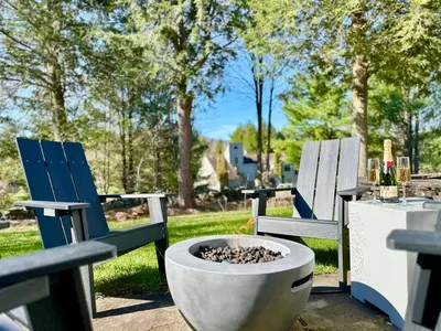 two chairs and a fire pit in a yard at Windham Ridge Chalet in Windham