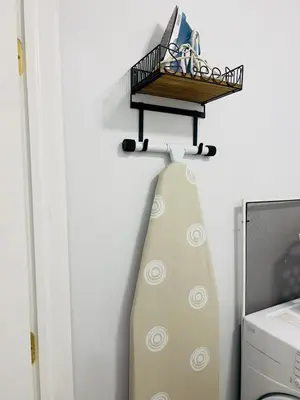 a surfboard hanging on a wall with a shelf at Newly renovated home, Fire pit, Games, Grill in Tobyhanna